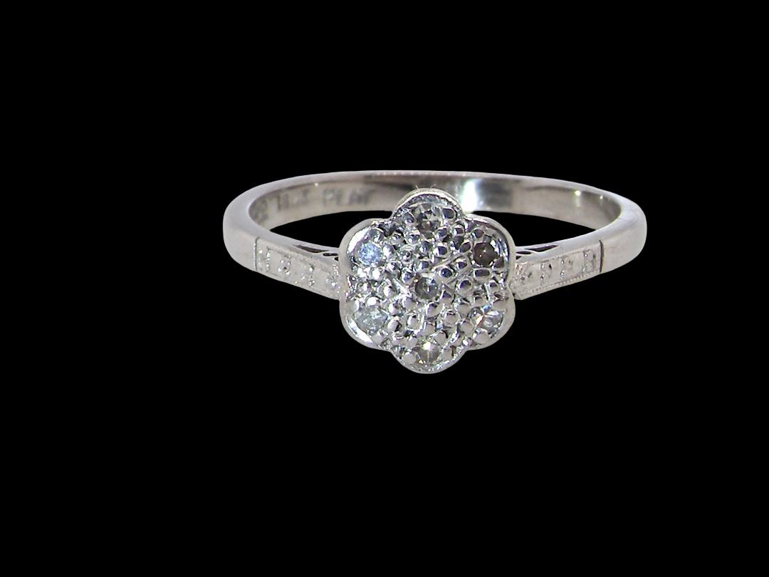 A vintage cluster ring, the head set with seven small single cut white diamonds, 