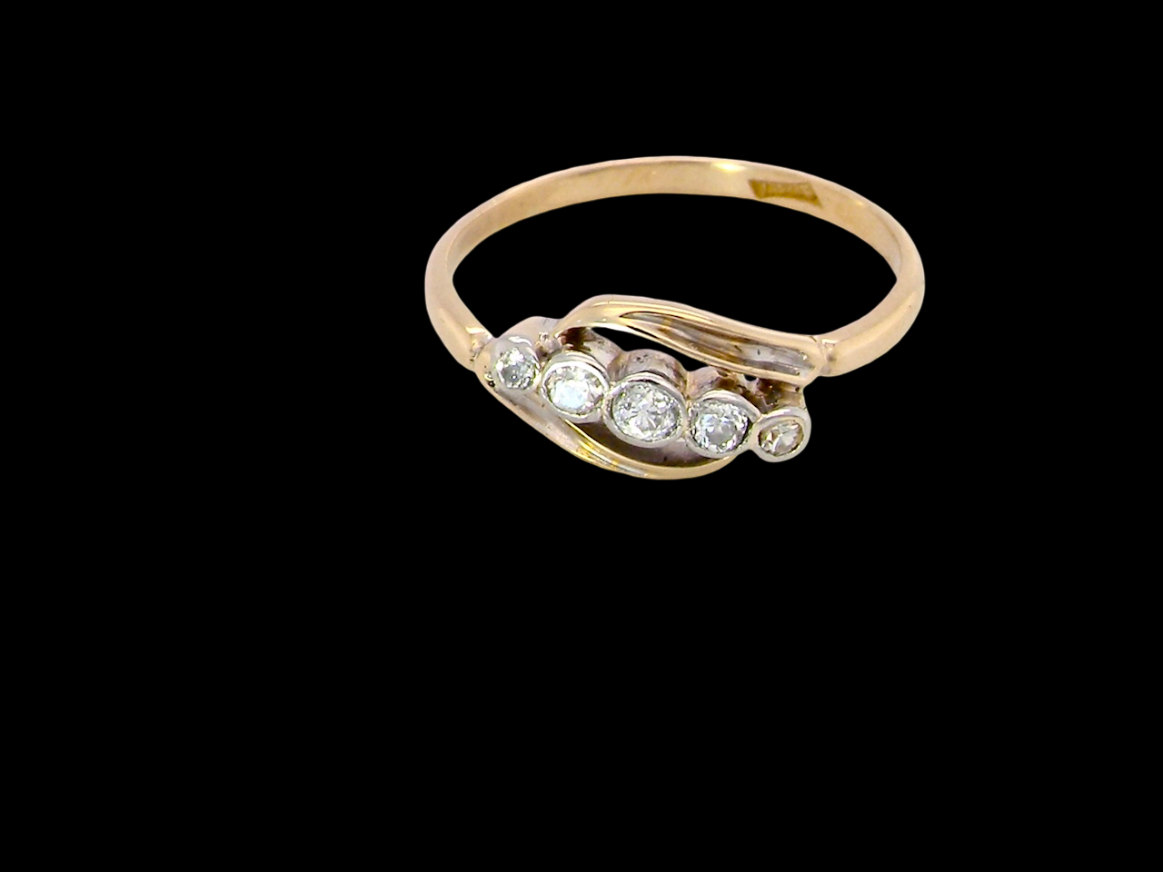A vintage cross over style ring. Set with five old brilliant cut white diamonds. Centre stone 3mm, each side 2.4mm, each end 1.5mm. Total diamonds  at 0.22 carats.
