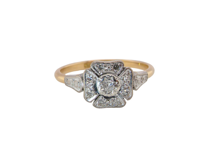 A vintage diamond cluster ring. Shaped like a four leaf clover, each leaf is pavé set with small white diamonds, two each x 1.5mm. Centre diamond 2.4mm.