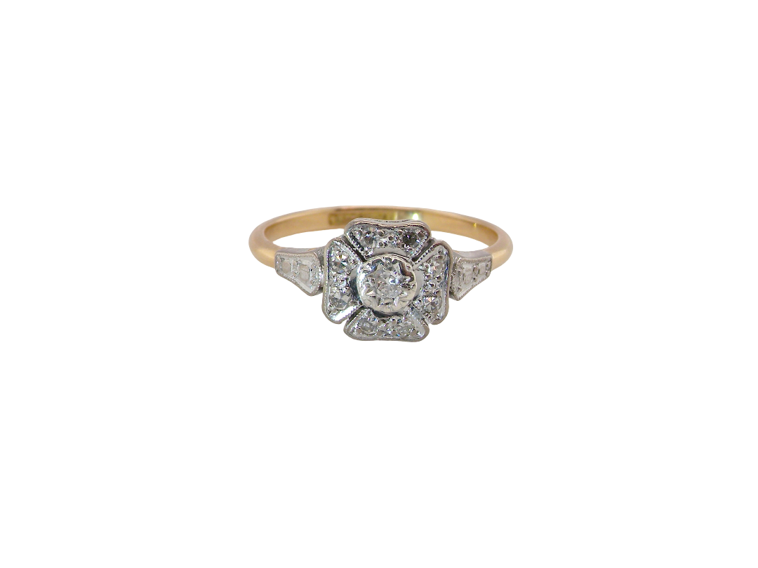 A vintage diamond cluster ring. Shaped like a four leaf clover, each leaf is pavé set with small white diamonds, two each x 1.5mm. Centre diamond 2.4mm. (total estimated total 0.17 carats)