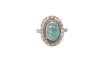 A vintage early 20th century cluster ring. Features to the centre a black opal doublet, 