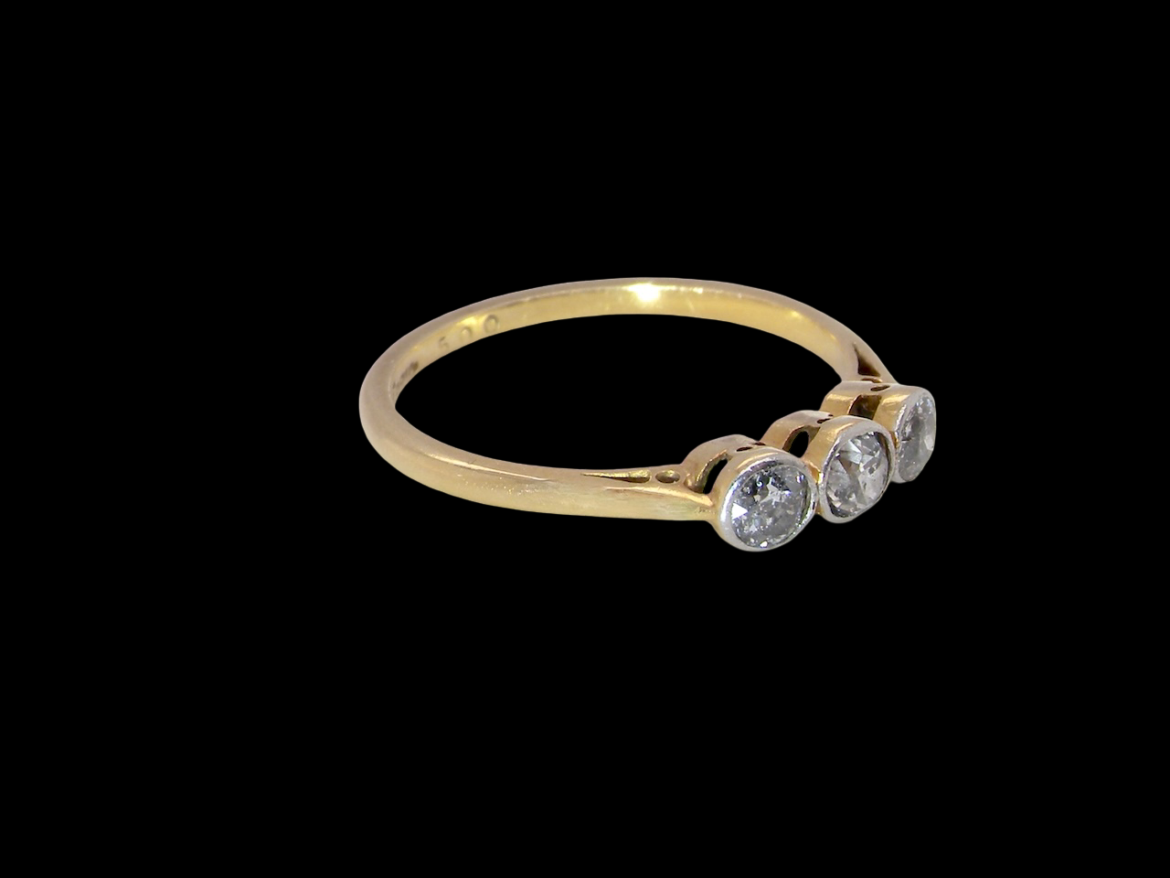 A vintage early 20th century trilogy ring. Set with three old cut diamonds, centre stone 3.8mm, and each side a 3.6mm diamond (total carat weight estimated at 0.55 carats) side
 