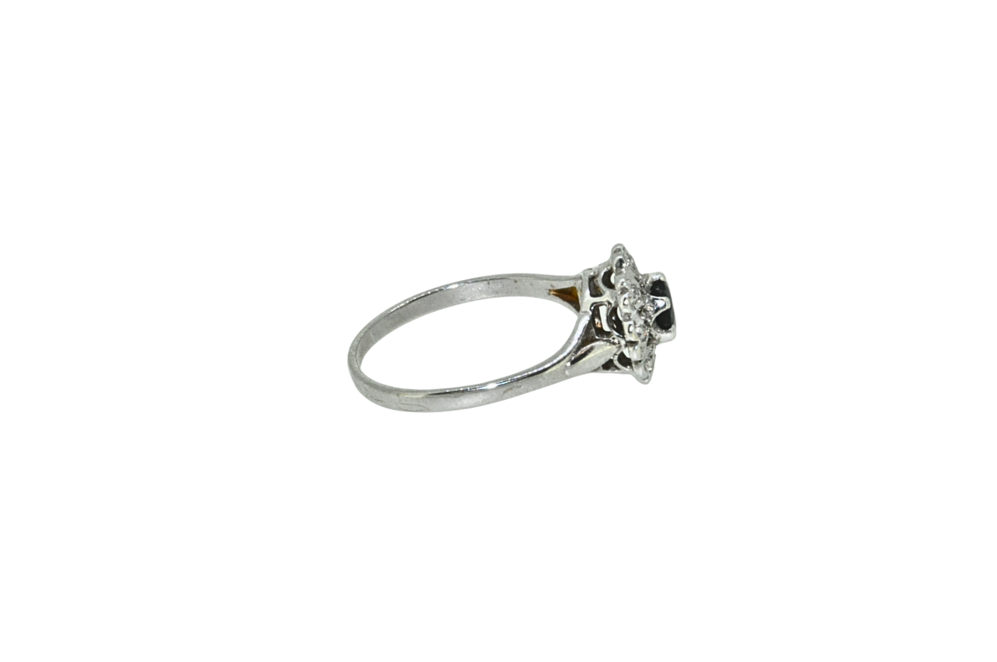 Side view of sapphire and diamond cluster ring