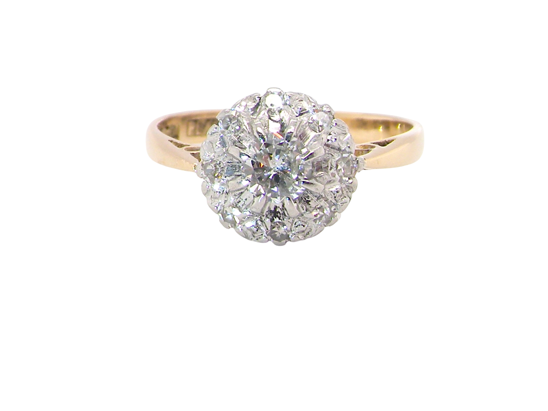 A vintage mid 20th century cluster ring. Principle stone a brilliant cut white diamond, 4mm (0.25 carats est) 