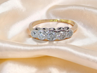 A vintage ring containing five old brilliant cut white diamonds. Centre 3mm, each side 2.2mm, at each end a 1.8mm diamond. Total diamond content estimated at 0.25 carats. 