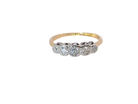 A vintage ring containing five old brilliant cut white diamonds. Centre 3mm, each side 2.2mm, at each end a 1.8mm diamond. Total diamond content estimated at 0.25 carats. All illusion set in platinum