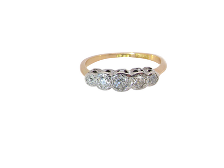 A vintage ring containing five old brilliant cut white diamonds. Centre 3mm, each side 2.2mm, at each end a 1.8mm diamond. Total diamond content estimated at 0.25 carats. All illusion set in platinum