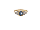 A vintage ring that features to the centre a substantial sapphire and to each side set in platinum three small diamonds.