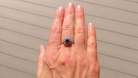 A vintage sapphire cluster ring on a hand