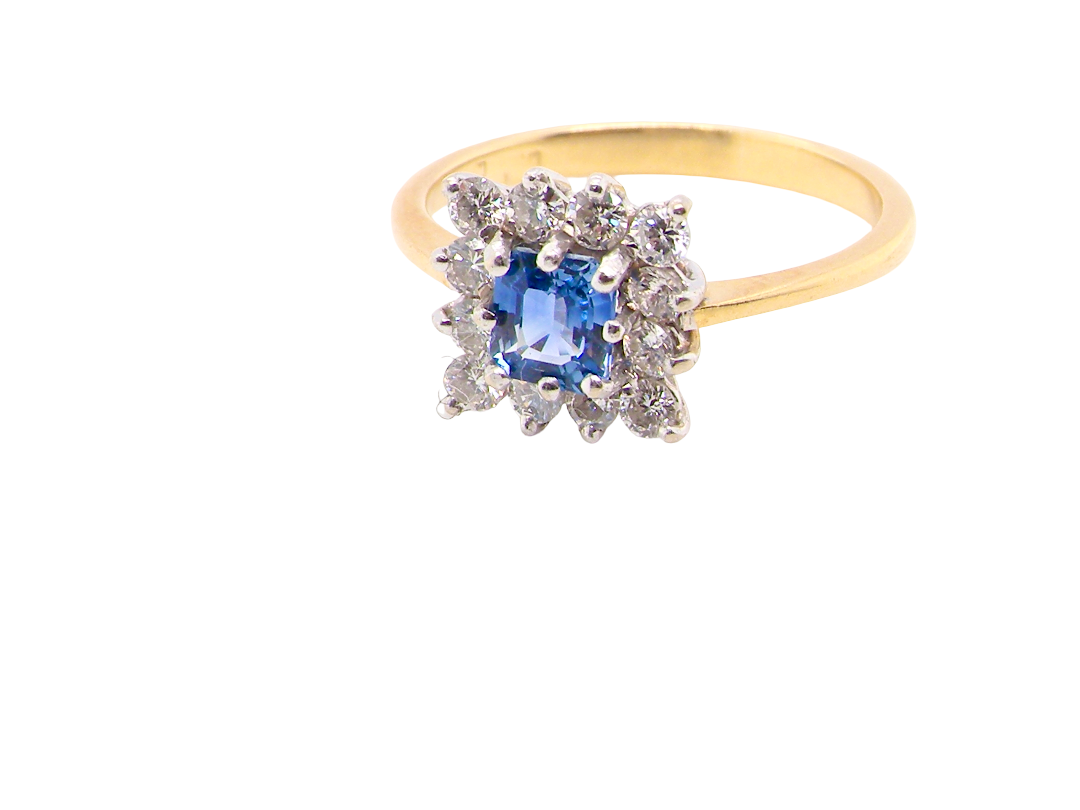 A vintage square cluster ring. Features to the centre a square sapphire 5x5mm (est 0.50 carats)  cornflower hue.&nbsp;
