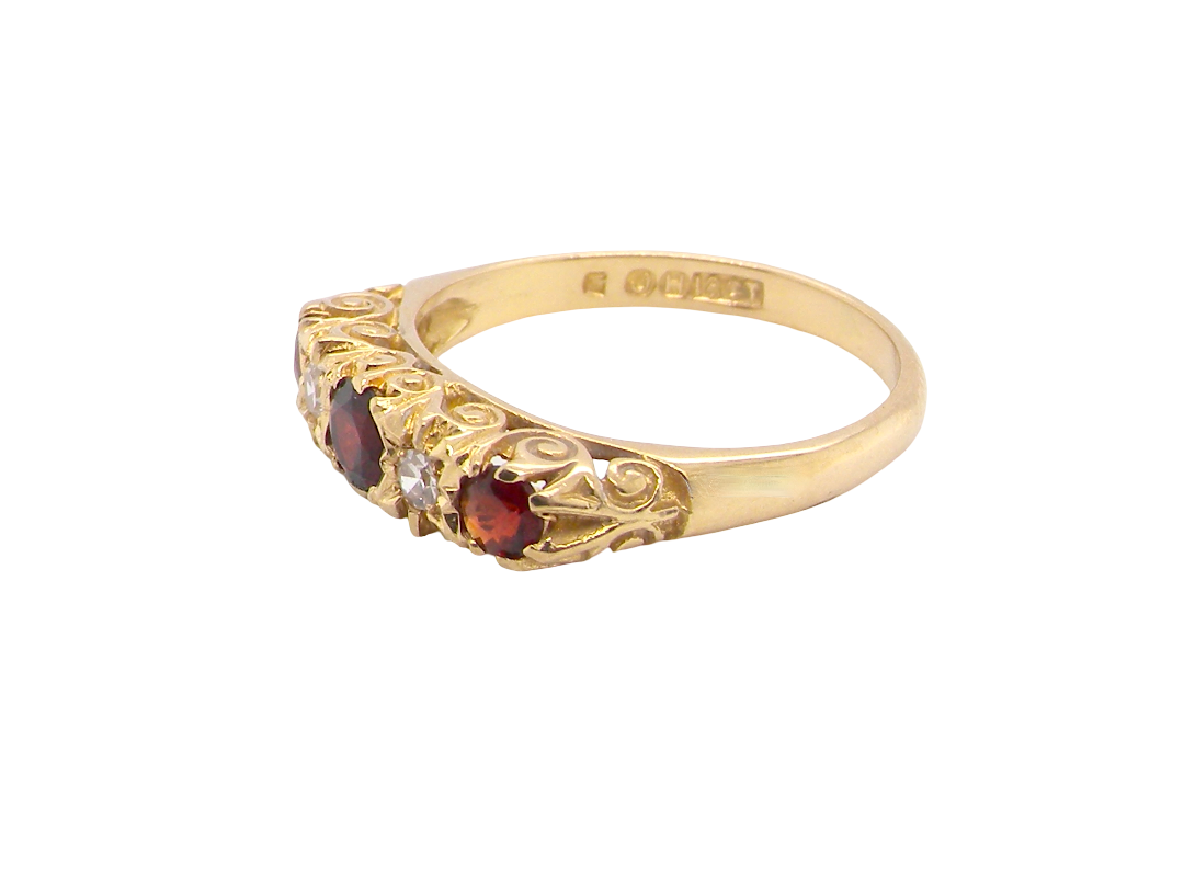 A vintage style 18 carat gold boat shaped ring. Features three dark red garnets, centre 4mm, each end a 3mm stone.&nbsp;
side