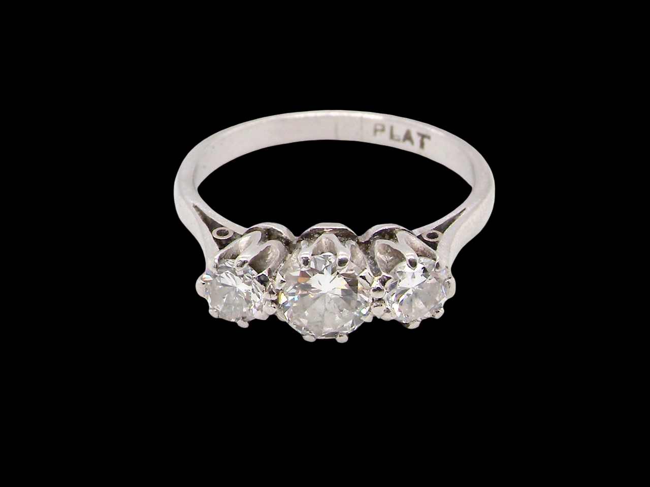 Diamond ring with 'PLAT' marking on a black background