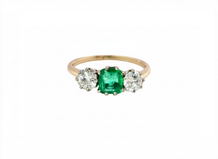 An emerald and diamond trilogy ring
