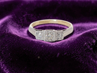 A vintage trilogy ring. Set with three old brilliant cut white diamonds, centre 3mm and each side a 2.4mm diamond. Total estimated at 0.20 carats, 