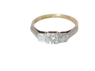 A vintage trilogy ring. Set with three old brilliant cut white diamonds, centre 3mm and each side a 2.4mm diamond. Total estimated at 0.20 carats, colour H-j, clarity Si
