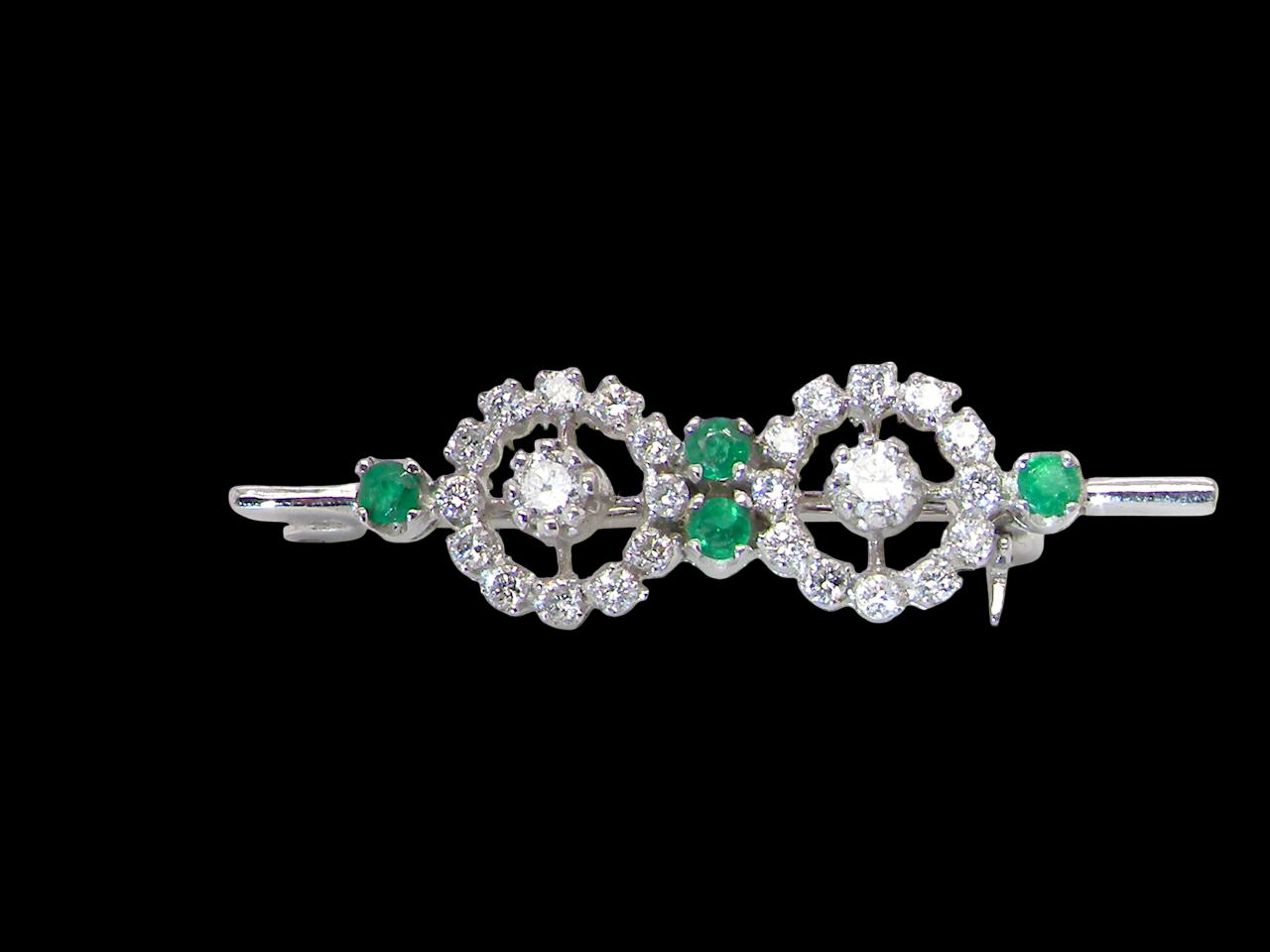 A wearable brooch. A double cluster of brilliant cut white diamonds, each set to the centre with an 0.10 carat stone and surrounded by twelve x 0.015 carat stones*. &nbsp;Total carat weight estimated at 0.60 carats*