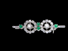 A wearable brooch. A double cluster of brilliant cut white diamonds, each set to the centre with an 0.10 carat stone and surrounded by twelve x 0.015 carat stones*. &nbsp;Total carat weight estimated at 0.60 carats*