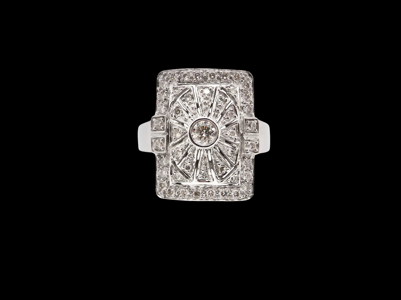 Diamond ring with a central gemstone and diamond-studded band on a black background