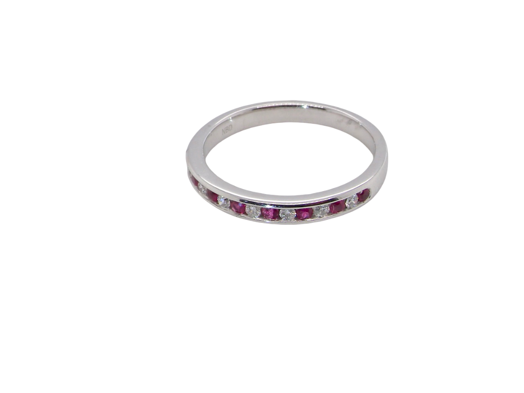 A white gold half hoop eternity ring. Set with seven round rubies and six brilliant cut white diamonds new