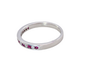 A white gold half hoop eternity ring. Set with seven round rubies and six brilliant cut white diamonds side