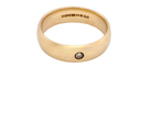 A wide 9 carat gold wedding ring. Set with a diamond
