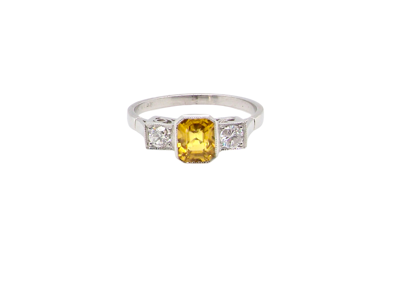 A yellow sapphire and diamond ring