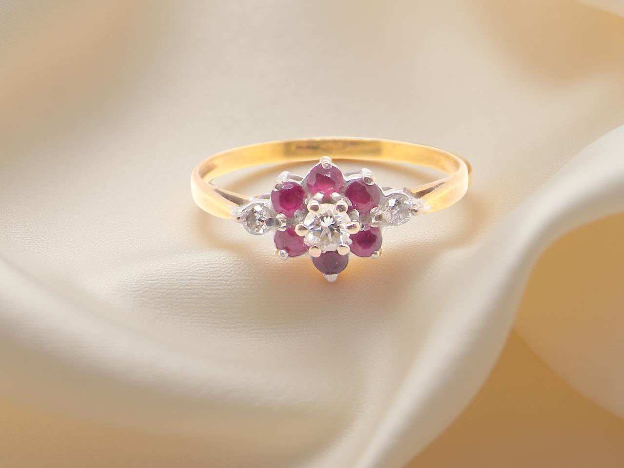 A Yellow Gold Diamond and Ruby Cluster Ring