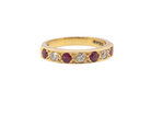 An 18 carat gold Ruby and Diamond eternity ring 1980s