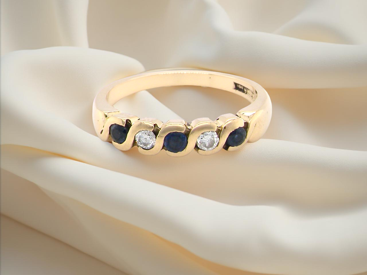 An 18 carat gold Sapphire and Diamond eternity ring