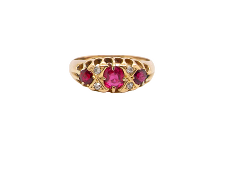 An 18 carat gold antique boat shaped ring. Features three lovely coloured wine red rubies, centre 5x4mm, 