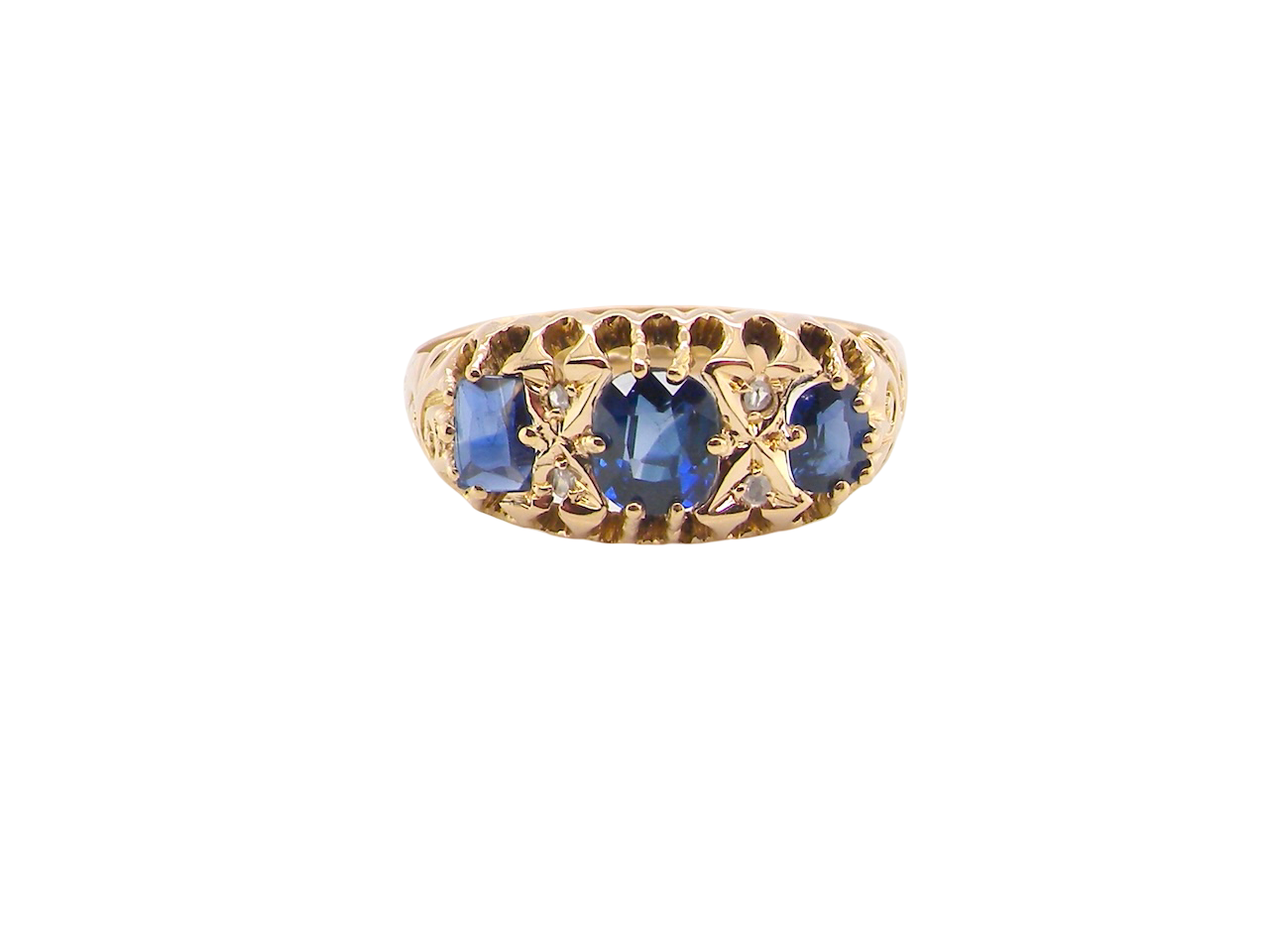 An 18 carat gold antique boat shaped ring. Features three oval to cushion cut sapphires, centre 6x5mm, each end 5x3mm. Mid to dark blue