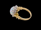 An 18 carat gold cluster ring. Features an oval opal centre stone with excellent play of colour with a predominance of watery purple and flashes of orange,  luminous green.
Measures 11x7mm.