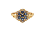 An 18 carat gold cluster ring.&nbsp; The centre a floral combination of seven sapphires, 