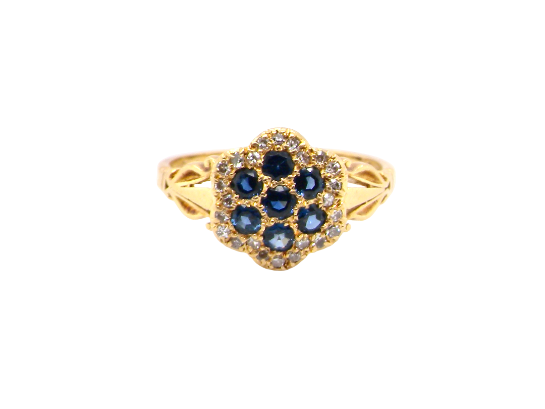 An 18 carat gold cluster ring.&nbsp; The centre a floral combination of seven sapphires, each 2.5mm, mid to dark blue.