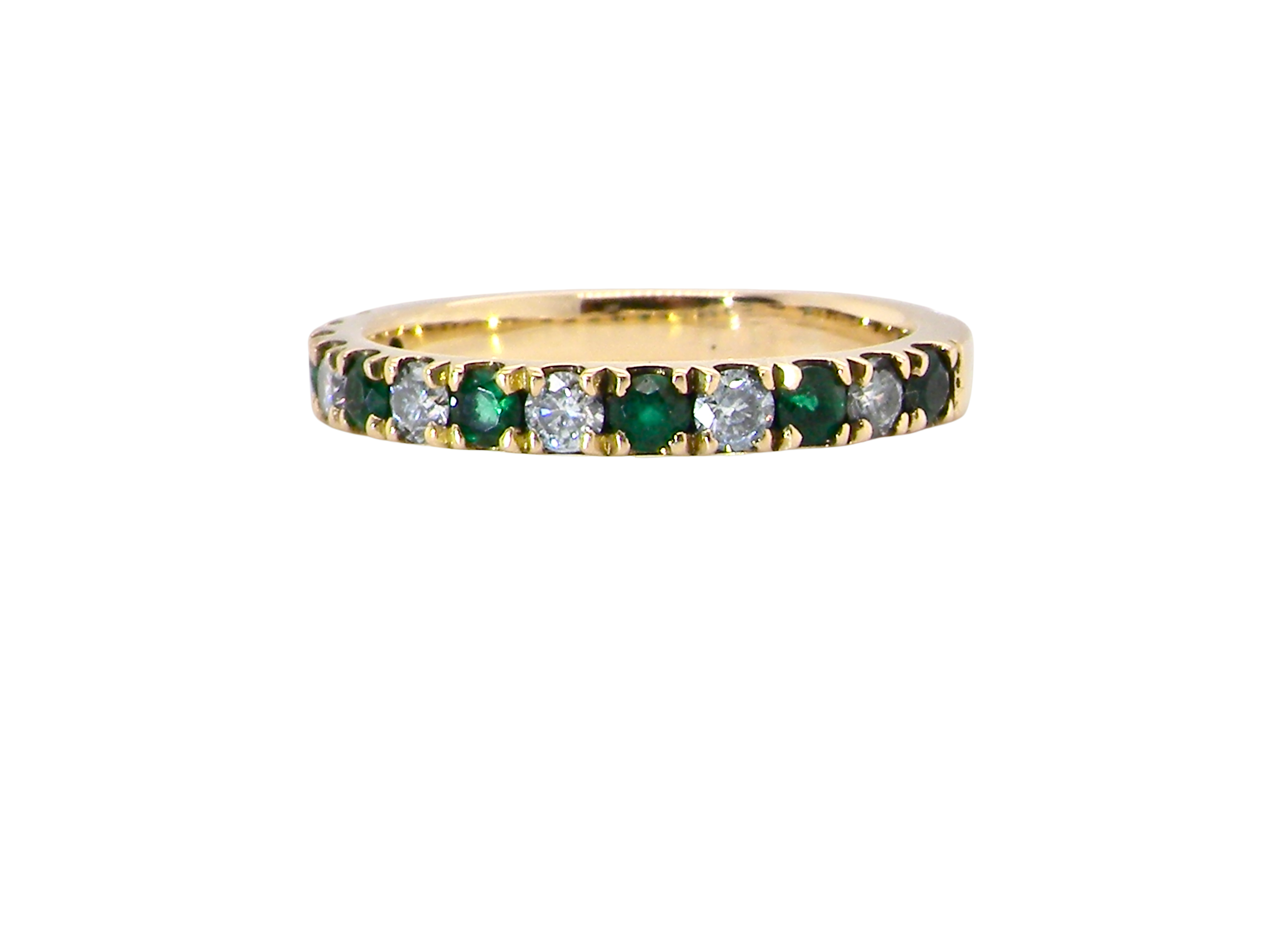 An 18 carat gold half-hoop eternity ring, set with&nbsp;round-cut emeralds