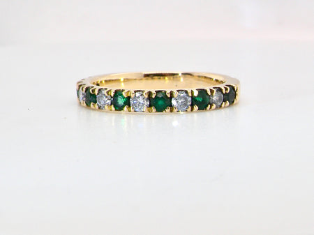 An 18 carat gold half-hoop eternity ring, with&nbsp;six round-cut emeralds