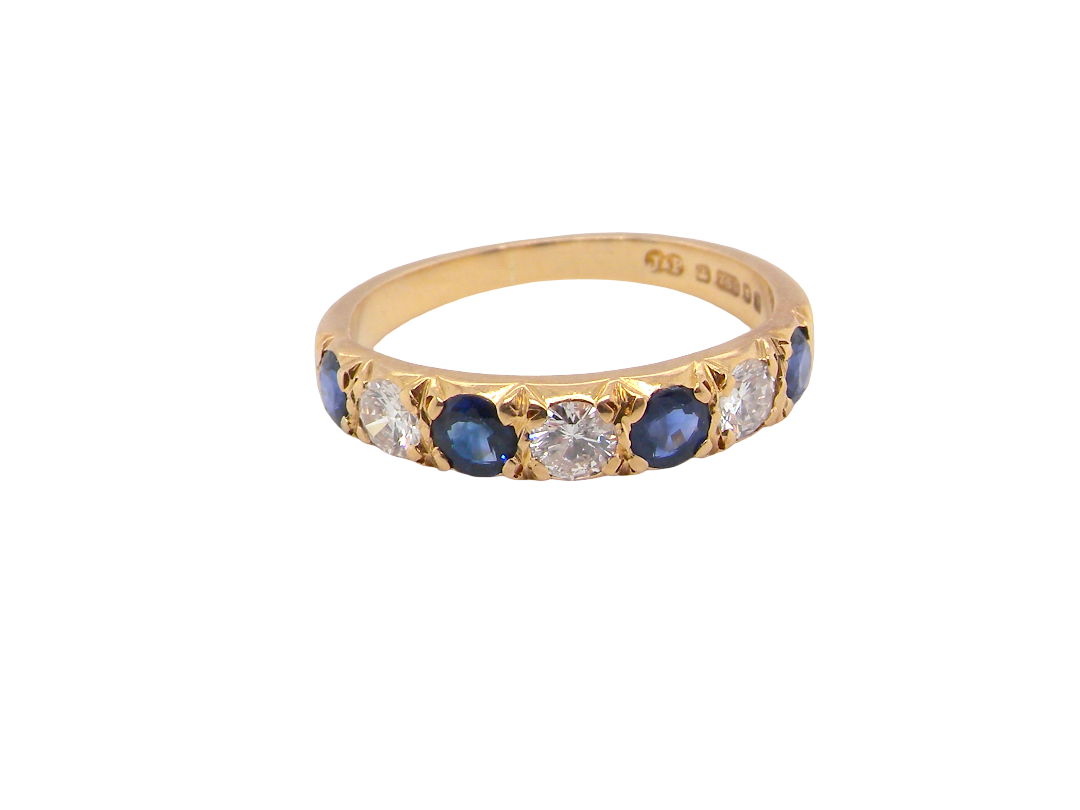 An 18 carat gold half hoop eternity ring. Set with four sapphires each 3.4mm (0.15 carats) and three diamonds, brilliant cut, 3.4mm 