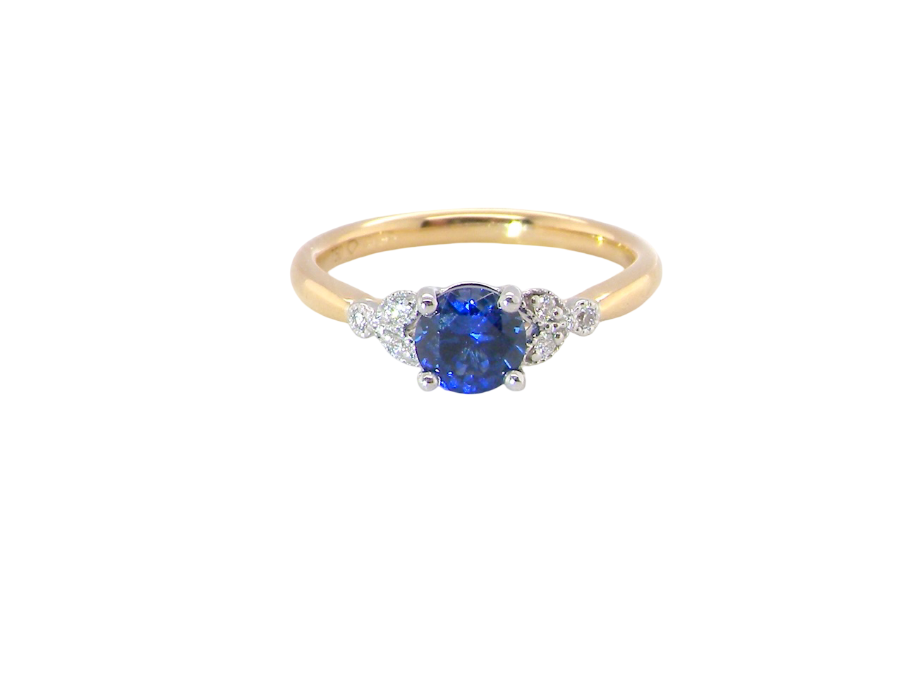 An 18 carat gold ring set with a vibrant blue sapphire, 