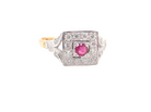 An 18 carat gold square cluster that features to the centre a round ruby and an outer halo of white diamonds.
