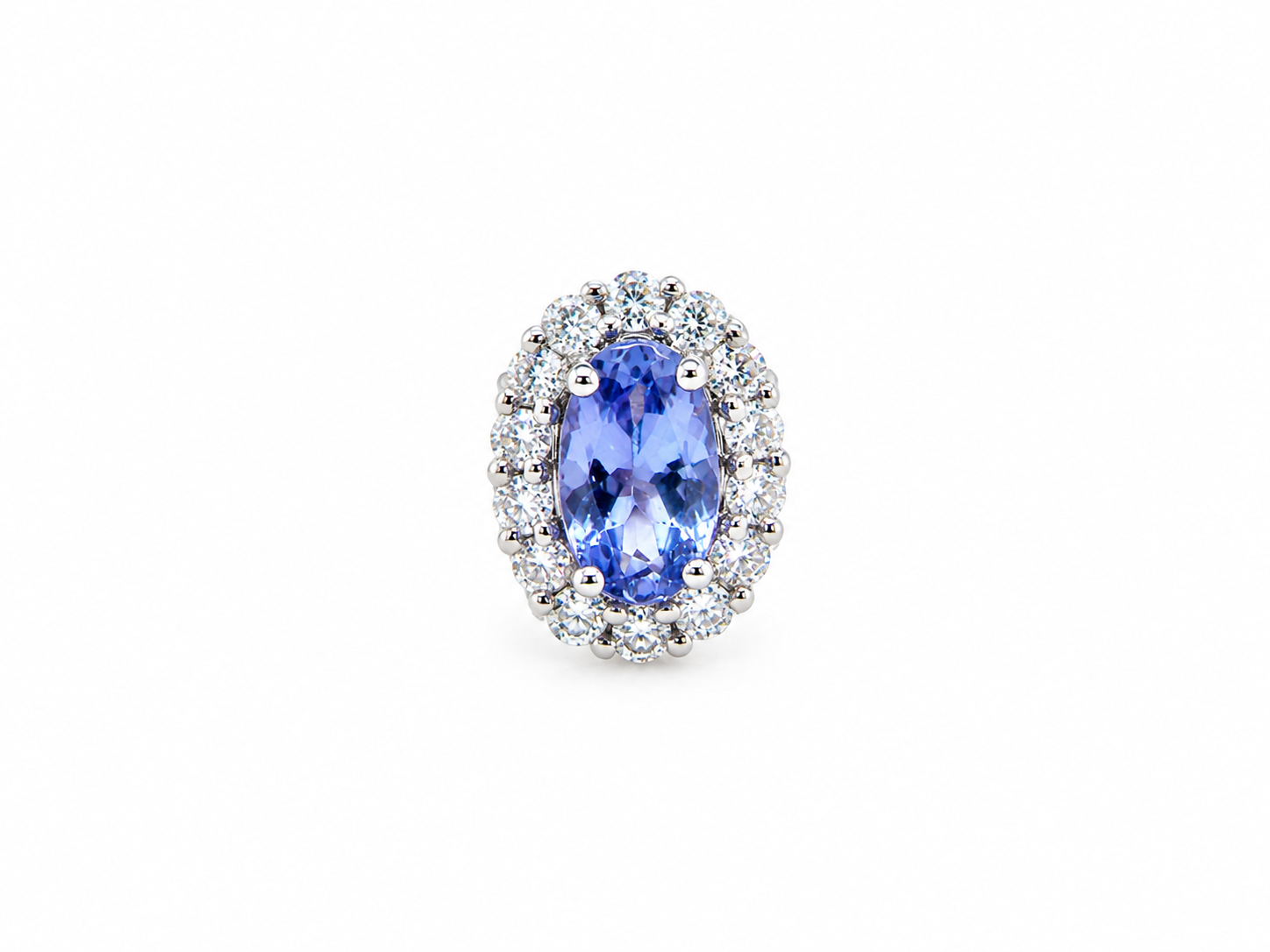 An oval halo ring featuring a central blue tanzite gemstone surrounded by a double halo of small clear round diamonds in a silver-colored setting, isolated on a white background.