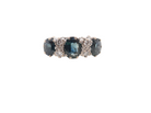 An 18 carat white gold * dress ring. Features three large sapphires, centre 8x6mm (est 1.25 carats) and each side a 7x5mm sapphire (est 0.75 carats), dark blue hues,