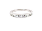 An 18 carat white gold half hoop eternity ring. Mixed cuts of white diamonds which consist of seven round brilliant stones, each 2mm diameter and eight baguette cut stones, each 2x1.5mm. 