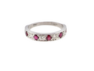 An 18 carat white gold half hoop eternity ring. Set with five round 3mm rubies (est 0.50 carats)&nbsp;
