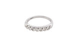 An 18 carat white gold half hoop eternity ring. Set with seven brilliant cut white diamonds,
