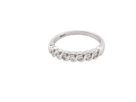 An 18 carat white gold half hoop eternity ring. Set with seven brilliant cut white diamonds,