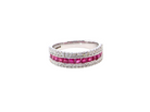 An 18 carat white gold half hoop ring. A triple row design with a line of channel set calibre cut rubies running along the centre , to a total carat weight of 0.97 carats.
