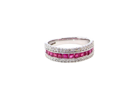An 18 carat white gold half hoop ring. A triple row design with a line of channel set calibre cut rubies running along the centre , to a total carat weight of 0.97 carats.
