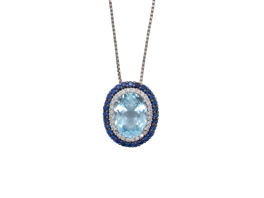 An oval pendant necklace featuring a light blue topaz center stone surrounded by a halo of silver-toned pavé diamonds and a border of deep blue sapphires, suspended from a silver-toned chain on a white background.