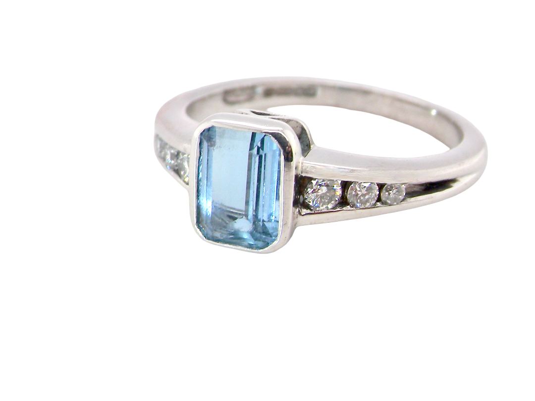 An 18 carat white gold ring, features a rectangular step cut aquamarine, measures 7x5mm (st one carat) sky blue, 