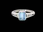 An 18 carat white gold ring, features a rectangular step cut aquamarine, measures 7x5mm (st one carat) , fine clarity. Rim setting.